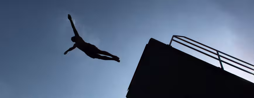 A man dives in to a swimming pool on Jul