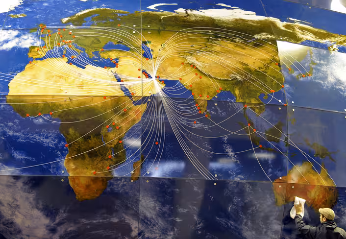 A stand builder cleans a giant world map