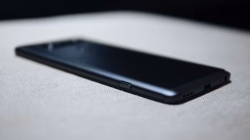 Press that little button to remove the back cover.