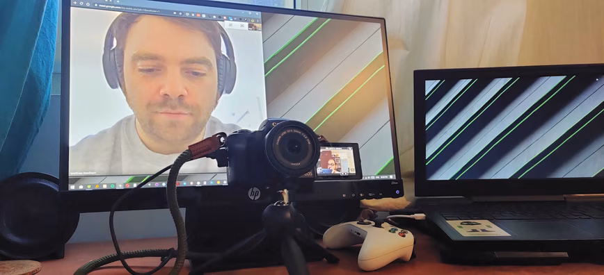I've placed my camera in front of my monitor so I can look into the lens and also see other people on the call