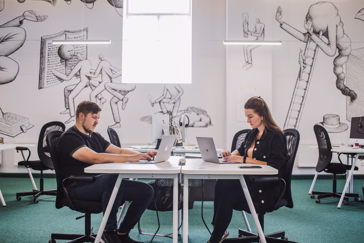 office workers in front of art