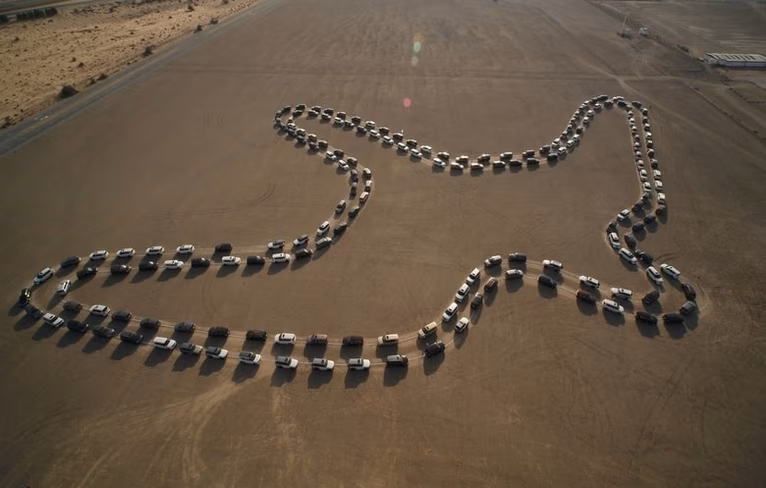 a formation of cars in the shape of a bird