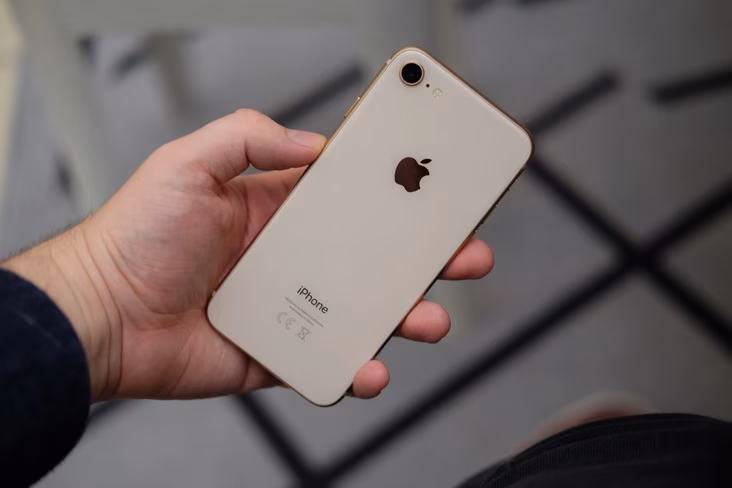 a picture of someone holding an iphone 8