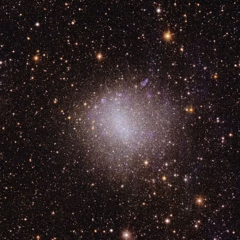 A square astronomical image is speckled with numerous stars visible across the black expanse of space. Most stars are visible only as pinpoints