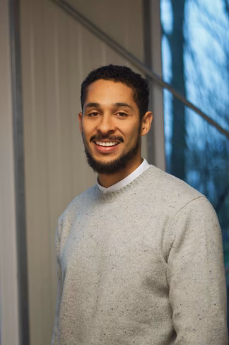 A portrait photo of Olivier Lugier wearing a grey sweater 
