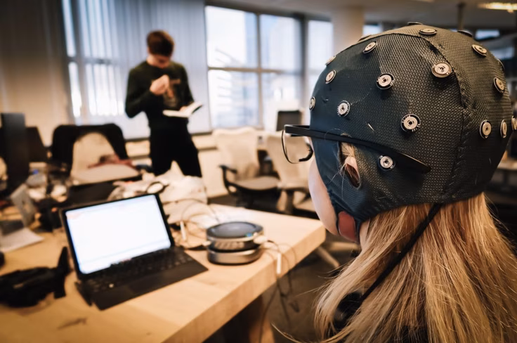Image of a research participant in an EEG study with the EEG cap on