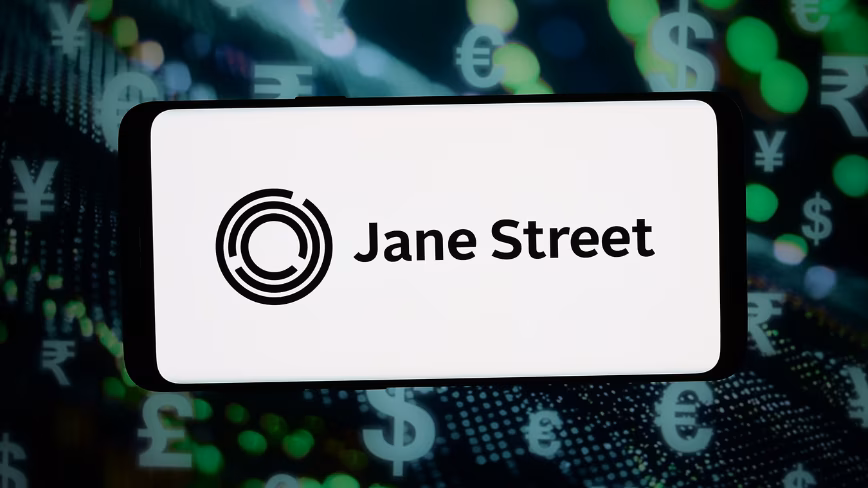 In this photo illustration, the logo of US trading company Jane Street Capital is displayed on a smartphone in front of abstract background on computer screen.