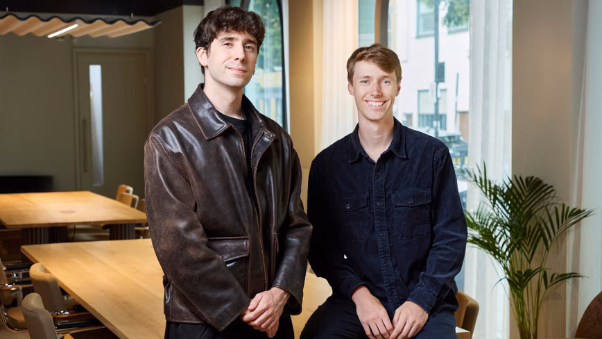 Magentic co-founders Odhran O'Donoghue, left, in a brown leather jacket, and Robin Van Aeken, in a navy shirt, in an office
