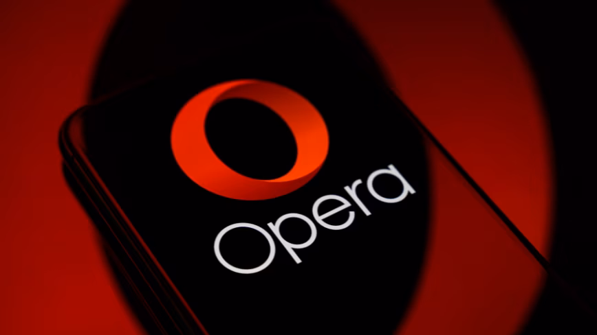 Paris, France - April 20, 2026: A smartphone showing the Opera logo, resting on a reflective surface with a circular red reflection projected in the background.