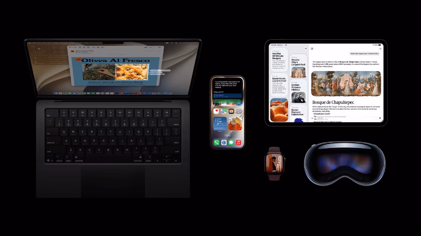 A MacBook, iPhone, iPad, Apple Watch, and Apple Vision Pro on a black background. The MacBook shows Mail, the iPhone shows a Siri reply confirming a scheduled meeting, and the iPad shows the Siri app answering a question about Mexico City's largest park.