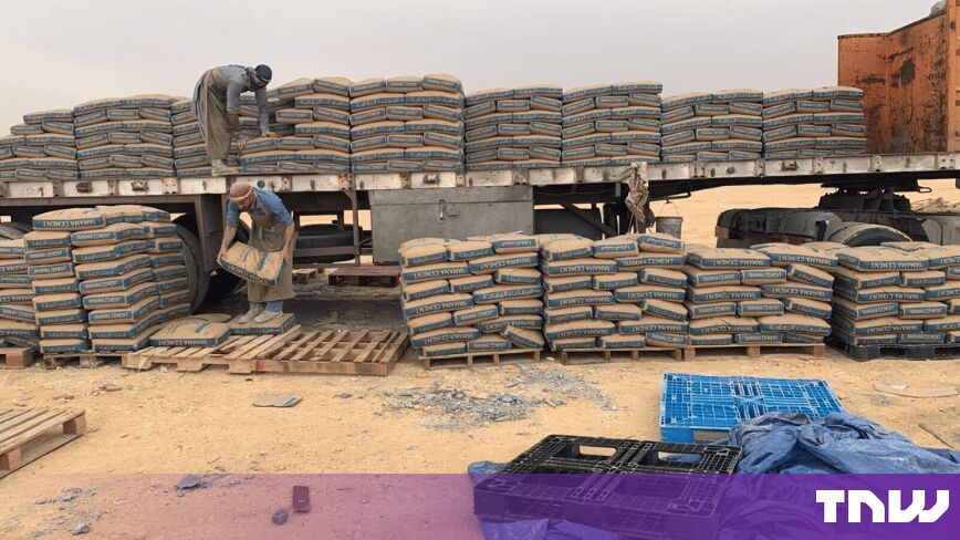 https://media.thenextweb.com/2026/09/brkz-workers-stacking-cement-sacks-depot.jpg