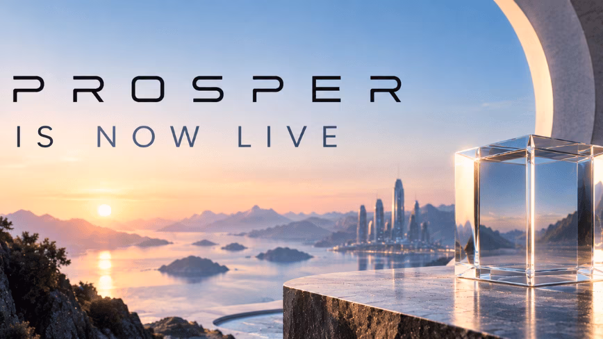 Promotional banner reading "PROSPER is now live" over a sunset sea with islands and a distant city skyline, beside a clear glass cube on a marble ledge under a white arch