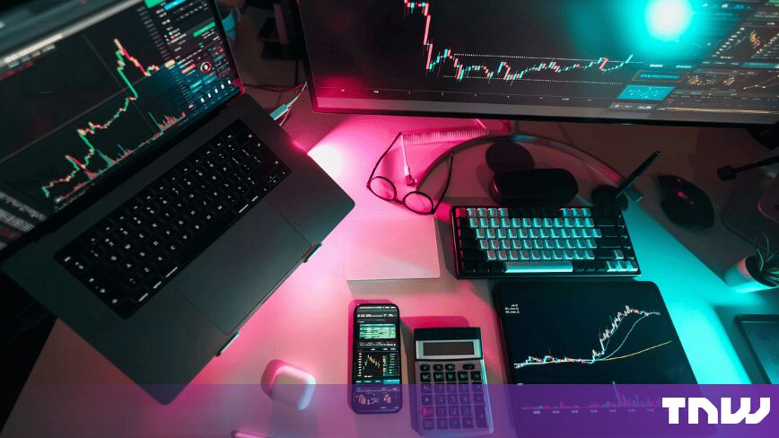 https://media.thenextweb.com/2026/09/trading-desk-laptop-monitor-tablet-candlestick-charts-neon-light.jpg