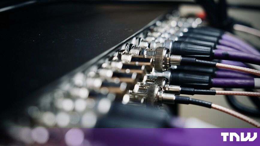https://media.thenextweb.com/2026/10/cables-plugged-into-back-panel-connectors-close-up.jpg