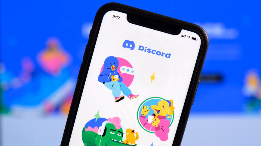 A phone showing the Discord app splash screen, with the logo and three cartoon characters.