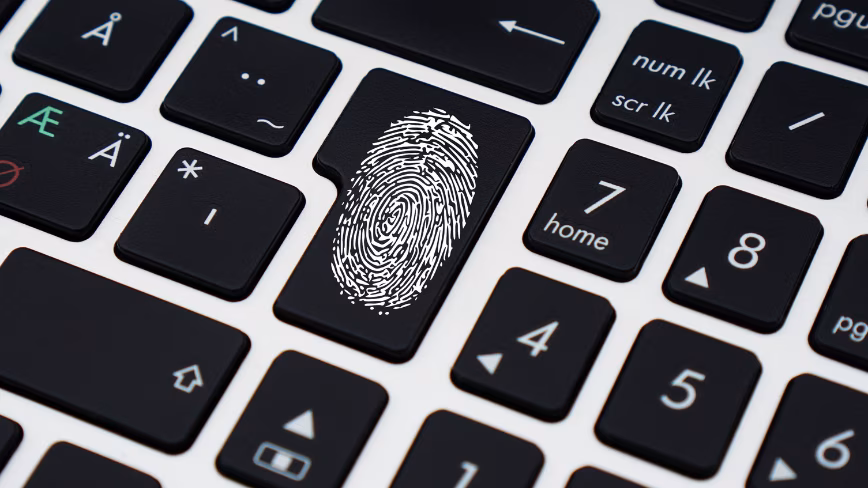 A white fingerprint printed across one key on a black laptop keyboard.