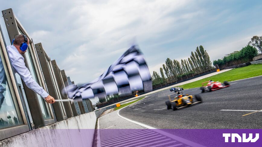 https://media.thenextweb.com/2026/10/marshal-waving-chequered-flag-race-car.jpg