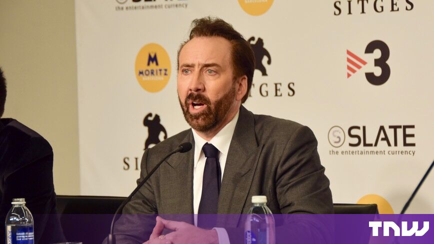 https://media.thenextweb.com/2026/10/nicolas-cage-press-conference-microphone-sitges.jpg