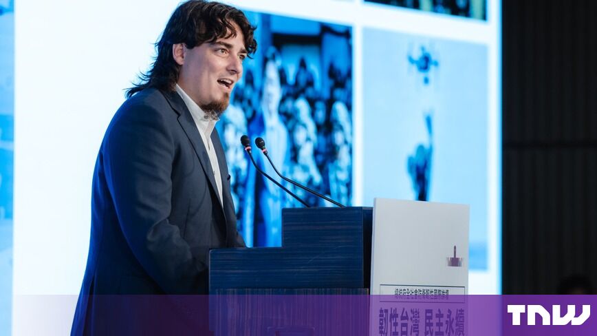 https://media.thenextweb.com/2026/10/palmer-luckey-speaking-podium-taipei-forum.jpg