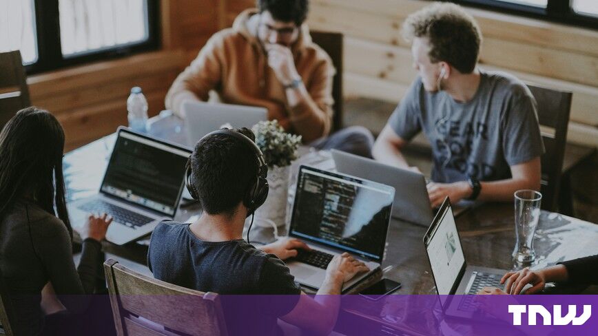 https://media.thenextweb.com/2026/10/team-laptops-wooden-table-headphones-coding.jpg