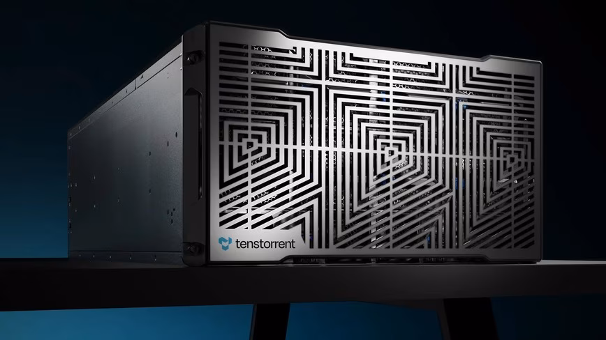 Tenstorrent server with a patterned metal front grille and the company logo, on a black table against a dark blue background