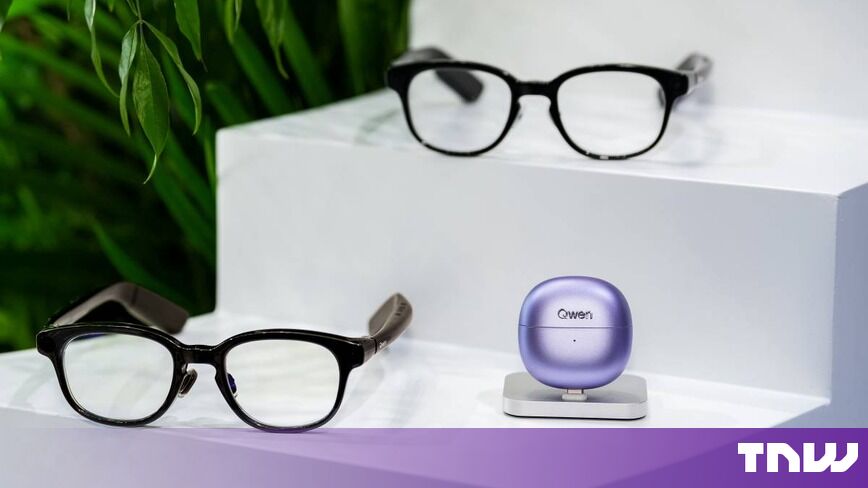 https://media.thenextweb.com/2026/10/two-black-smart-glasses-lilac-earbud-case-white-steps.jpg